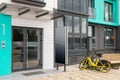 Glass entrance door to dwelling house with yellow public share bike near it