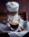 Glass of Espresso Macchiato and Latte Macchiato with Brown Sugar Royalty Free Stock Photo