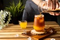Glass of espresso with orange juice on wooden table and copy space, Summer Cocktail, Cold brew coffee or black tea.