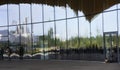 Glass facade of the building of Central Library Oodi in Helsinki, Finland, reflections and a dog