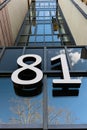 On the glass facade of the building the house number 81 is indicated