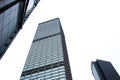 Glass facade business building bottom view in Hong Kong city. Office building and skyscrapers facade with glass window Royalty Free Stock Photo