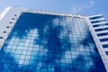 The glass facade of a modern building. High building. Reflection of the sky in the windows Royalty Free Stock Photo