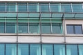 Glass facade of a modern building with metal vertical supports and external structural elements Royalty Free Stock Photo