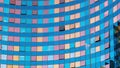 The glass facade of a modern building. Multicolored reflections in the windows. Squares and lines. Geometric abstract background Royalty Free Stock Photo