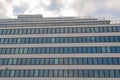 Glass facade of modern office building with blue sky and clouds reflection Royalty Free Stock Photo