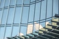 Glass facade of an office building with reflections of the blue sky and clouds Royalty Free Stock Photo