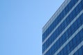 glass facade of a skyscraper against a blue sky Royalty Free Stock Photo