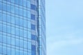 The glass facade of a skyscraper with a mirror reflection of sky windows Royalty Free Stock Photo