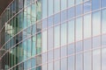 The glass facade of a skyscraper with a mirror reflection of sky windows Royalty Free Stock Photo