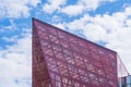 Glass Facade of Violet Tinted Semi-Transparent Glass Building Against Blue Sky with Sunbeams