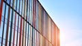 Blue curtain wall made of toned glass and steel constructions under blue sky. A fragment of a building. Royalty Free Stock Photo