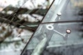 Glass facades a closeup of chrome fasteners.