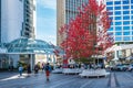 Glass facades of high-rise buildings in downtown of Vancouver in summer. Pedestrians walks on the street of modern city Royalty Free Stock Photo