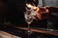 Glass of fiery cocktail on the bar counter Royalty Free Stock Photo