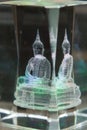 Glass figure of a seated Buddha