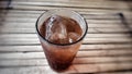 a glass filled with cold sweet iced tea on a bamboo table Royalty Free Stock Photo