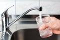 Glass filled with drinking water from kitchen faucet. Royalty Free Stock Photo