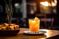 a glass filled with freshly squeezed pineapple juice set against the backdrop of a busy bar. Royalty Free Stock Photo