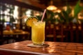 a glass filled with freshly squeezed pineapple juice set against the backdrop of a busy bar. Royalty Free Stock Photo