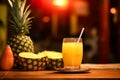 a glass filled with freshly squeezed pineapple juice set against the backdrop of a busy bar. Royalty Free Stock Photo