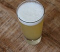 glass filled with radler, mixture of beer and sparkling lemonade, on wooden background Royalty Free Stock Photo