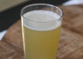 glass filled with radler, mixture of beer and sparkling lemonade, on wooden background Royalty Free Stock Photo