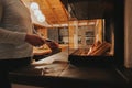 Glass fireplace in the interior of a cozy wooden chalet.hands hold a flint and set fire to firewood. Fireplace in the