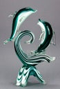 Glass fish figurine on gray background