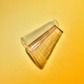 A transparent glass vase empty lies on a yellow paper background with soft shadows Royalty Free Stock Photo