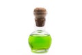 Glass flask with green liquid with a cork stopper on a white background Royalty Free Stock Photo