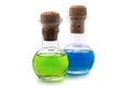 Glass flasks with green and blue liquid with a cork stopper on a white background Royalty Free Stock Photo