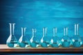 Glass flasks and test tubes with water on a blue background. Chemical laboratory. Generative AI Royalty Free Stock Photo