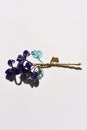 A glass flower twig, three blue flowers with golden stamens