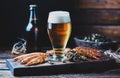 a glass of foamy beer stands on the table