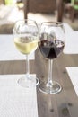 a glass of fragrant white and a glass of ruby red wine on a wooden table in a restaurant Royalty Free Stock Photo