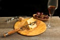 Glass of french wine and wedge of cheese with bowl of red grapes Royalty Free Stock Photo