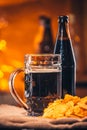 Glass of fresh beer, a bottle beer and chips on sacking Royalty Free Stock Photo