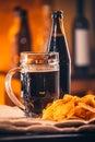Glass of fresh beer, a bottle beer and chips on sacking Royalty Free Stock Photo