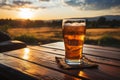 Glass of fresh beer on a wooden table on sunny summer day. Beer on a background of wheat field. Drinking alcoholic beverage Royalty Free Stock Photo