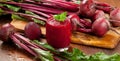 Glass of fresh beetroot juice with bets on wooden table. Royalty Free Stock Photo