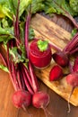 Glass of fresh beetroot juice with bets on wooden table. Royalty Free Stock Photo