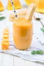 Glass of fresh cantaloupe smoothie with cookies and birch staraw Royalty Free Stock Photo