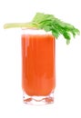 A glass of fresh carrot juice with celery leaves