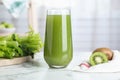 Glass with fresh celery juice on white marble table, closeup Royalty Free Stock Photo