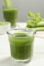 Glass of fresh celery juice on white table, closeup Royalty Free Stock Photo