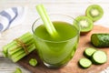 Glass of fresh celery juice on white wooden table, closeup Royalty Free Stock Photo