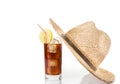 Glass of fresh coke with straw near summer hat on top, summer time