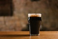 glass of fresh cold dark beer on wooden table Royalty Free Stock Photo