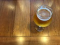 Glass of fresh cold draught beer on wood table with beautiful natural lighting Royalty Free Stock Photo